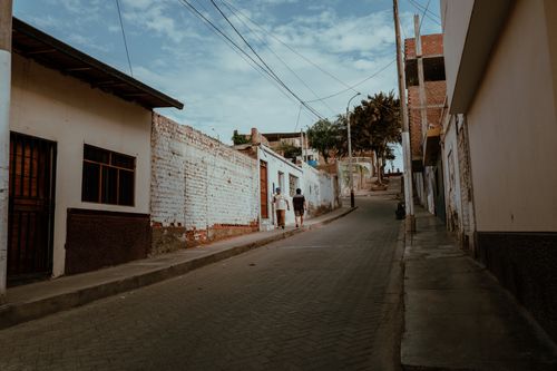 Free Street view showcasing traditional Peruvian architecture in Pacasmayo with local pedestrians. Stock Photo