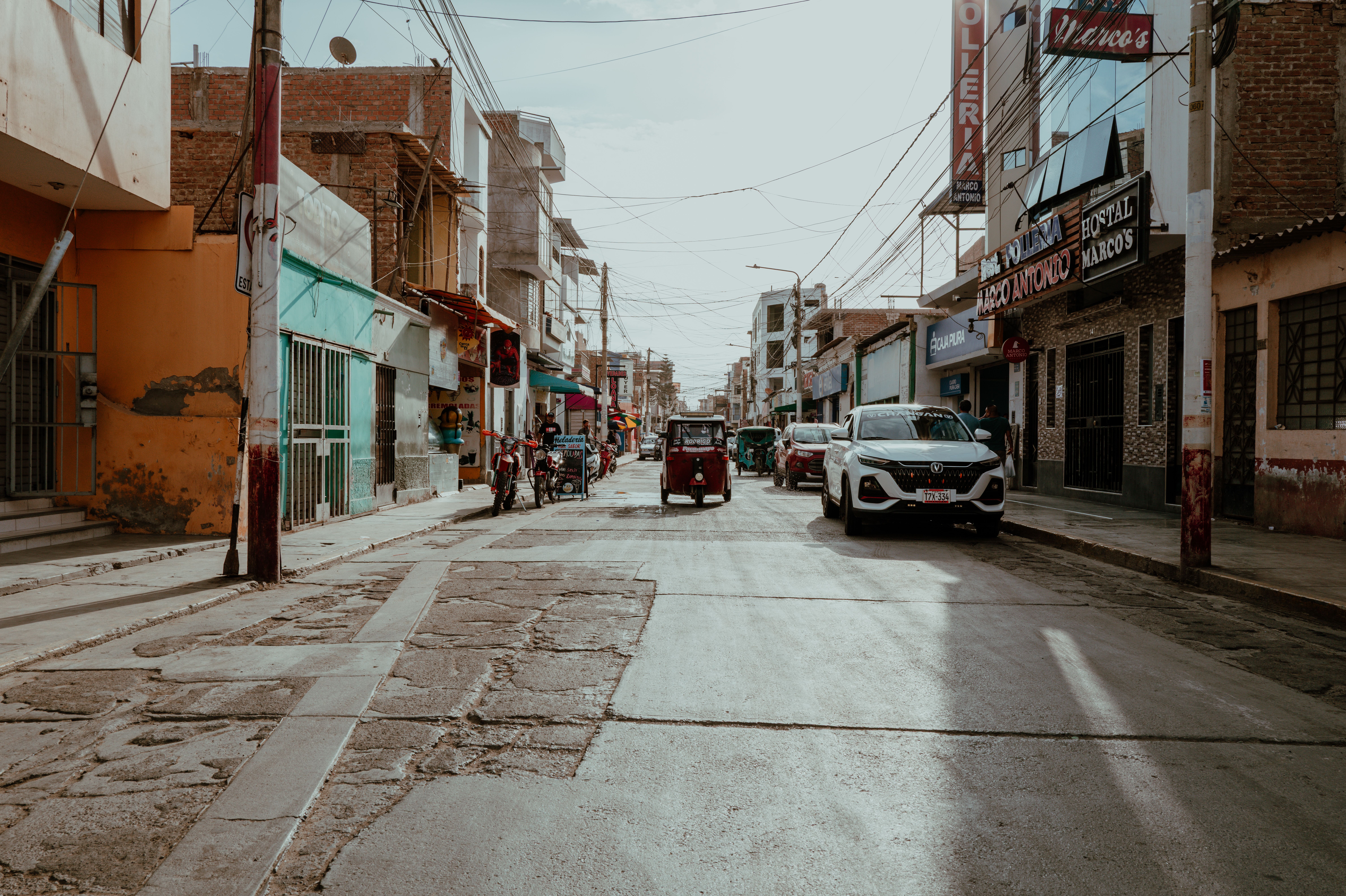 Motoconcho (motorcycle taxi) driving through a city in the Dominican Republic