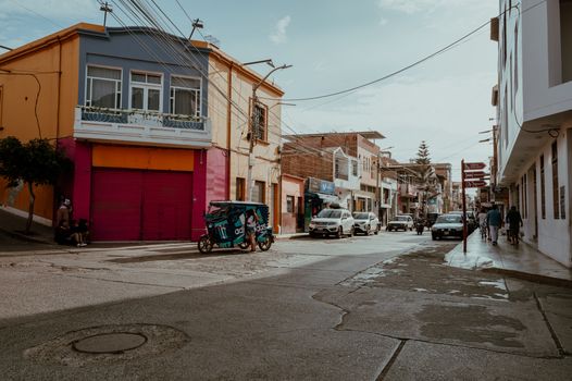 A lively street view in Pacasmayo showcasing colorful architecture and local life in Peru.