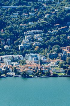 Scenic aerial view of a vibrant town by the water in Lombardy, Italy, showcasing vibrant architecture.