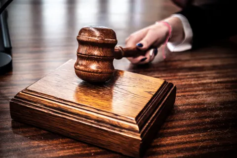Wooden gavel resting on a judge's desk