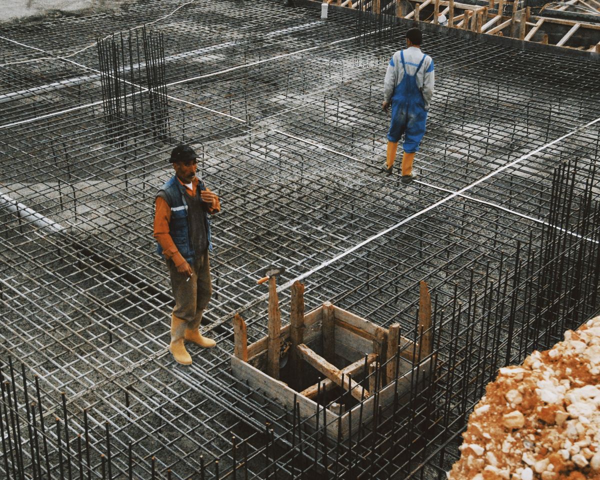 Construction crew reviewing steel reinforcement before an RCC pour