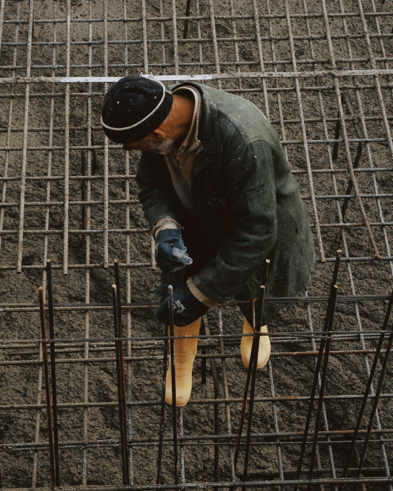 Construction workers smoothing fresh concrete outdoors