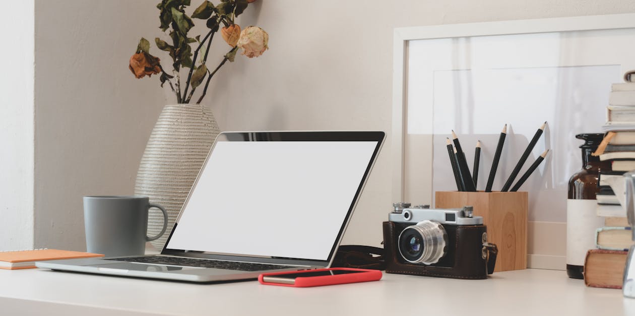 Analog Camera Behind Computer Laptop