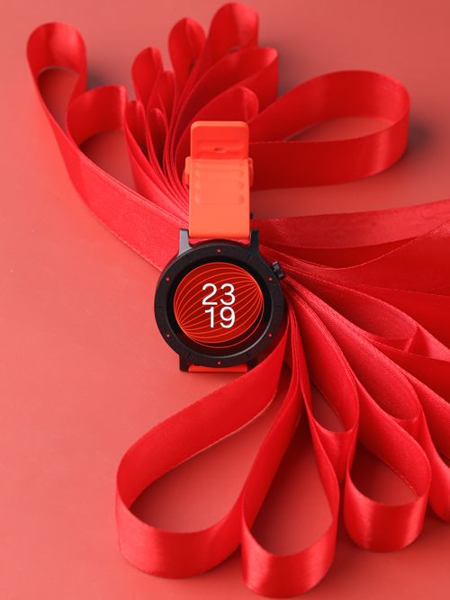 Free A stylish modern watch set against a red ribbon background, showcasing sleek design and elegance. Stock Photo