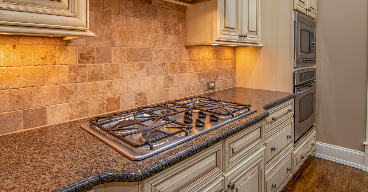 Elegant kitchen featuring granite countertops and stainless steel appliances.