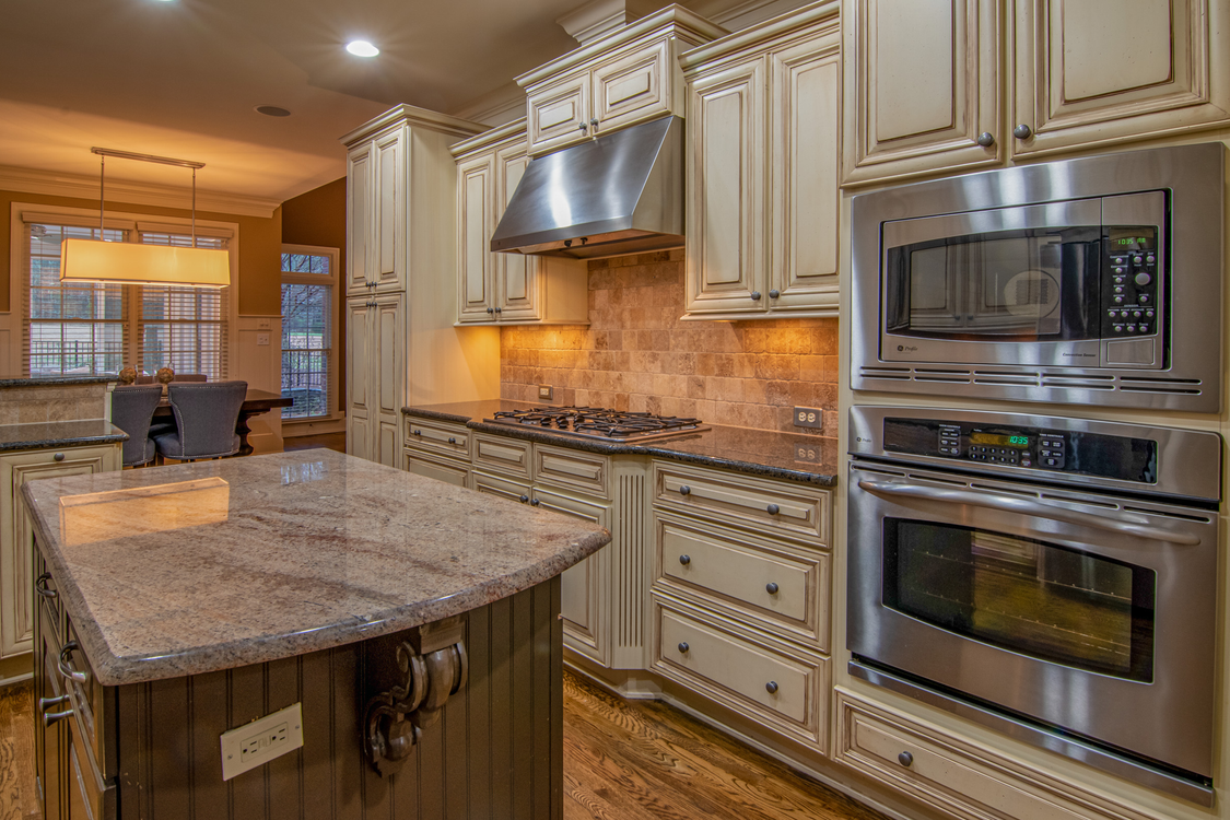 Silver Microwave Oven on Brown Wooden Kitchen Cabinet