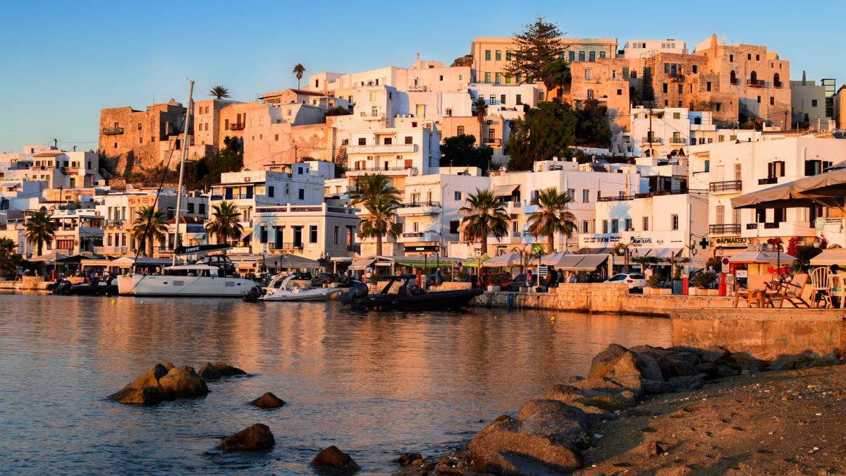 Naxos Town and harbor at golden sunset with traditional Cycladic buildings
