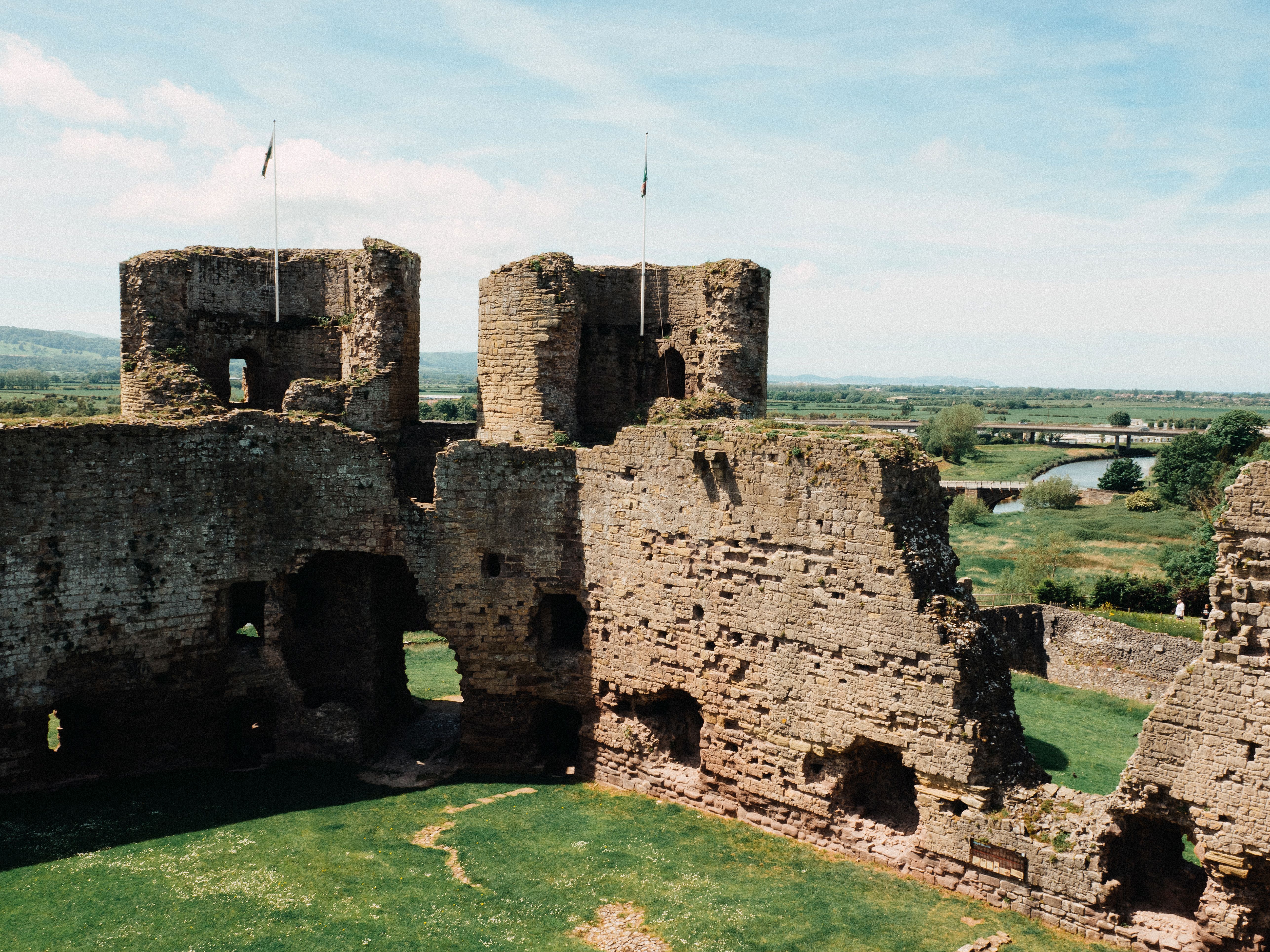 Explore the ancient ruins of Rhuddlan Castle, showcasing medieval architecture in the lush Welsh landscape.