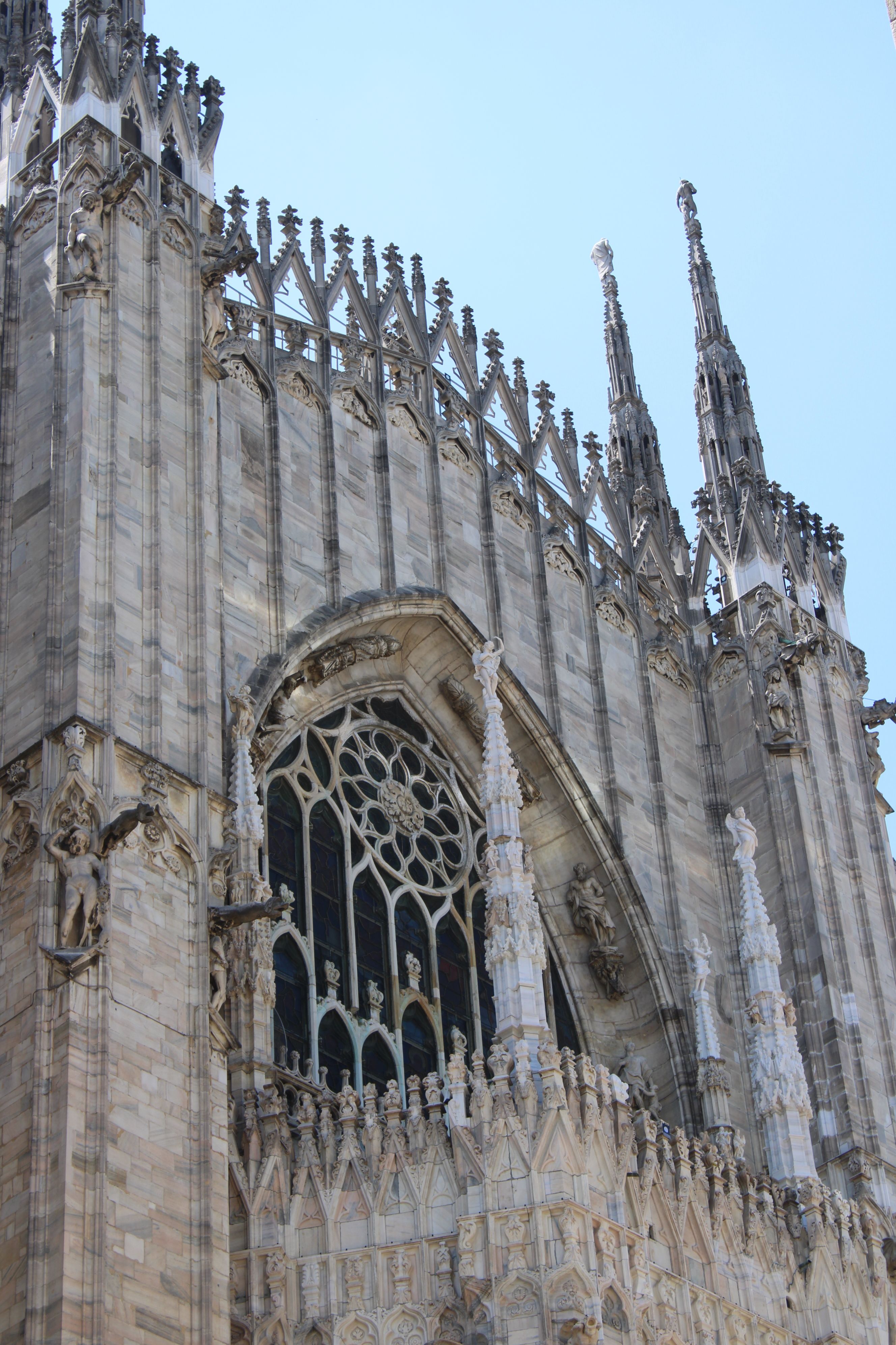 Elegant Gothic architecture details of the Duomo di Milano, showcasing intricate stone carvings.