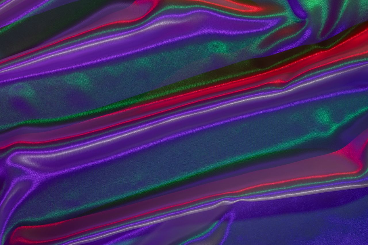 abstract image of vibrant neon satin like fabric with flowing colorful