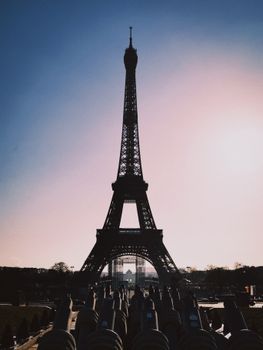 Dramatic silhouette of the Eiffel Tower at dusk with a pastel sky.