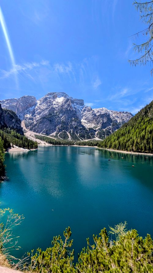 Free Crystal clear waters and majestic mountain backdrop at Lago di Braies, a scenic gem in Northern Italy. Stock Photo
