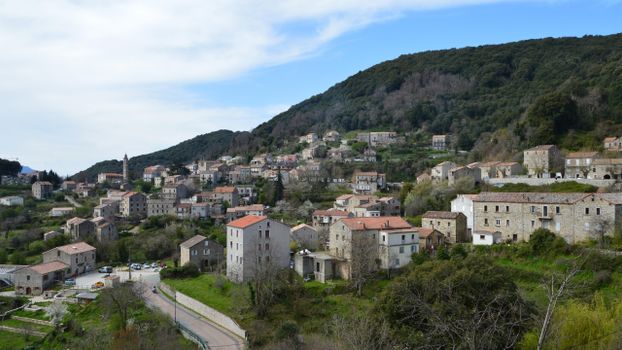 Picturesque view of the village Levie in Corsica, France surrounded by hills and greenery.
