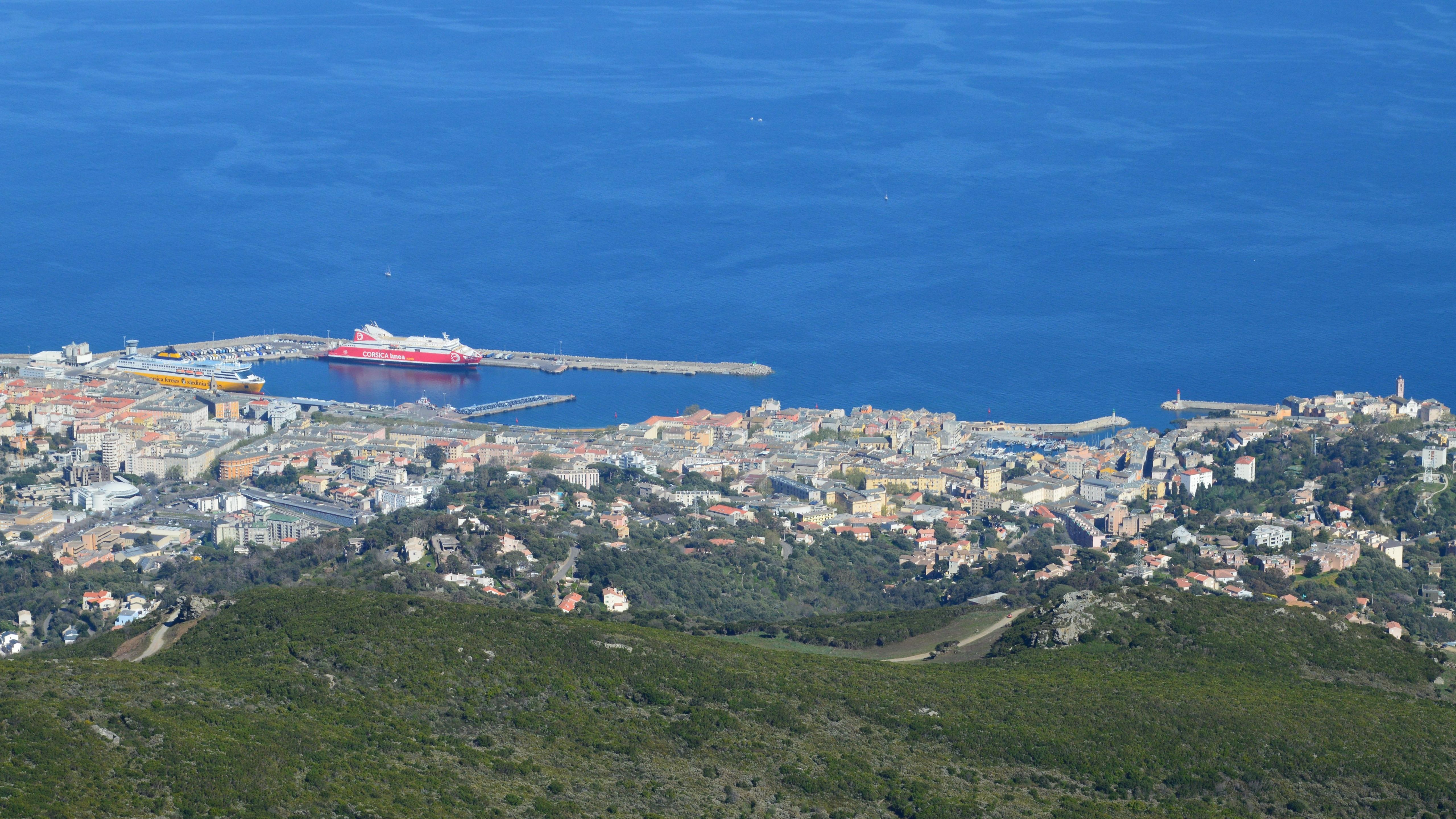 Stunning aerial shot of Bastia harbor and city against the Mediterranean Sea in Corsica, France.
