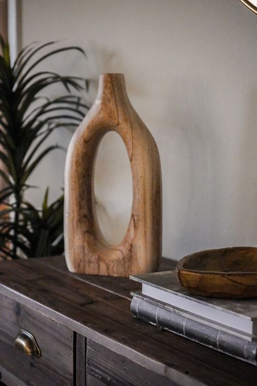 Free A wooden vase sits atop a rustic dresser, embodying minimalist decor style. Stock Photo