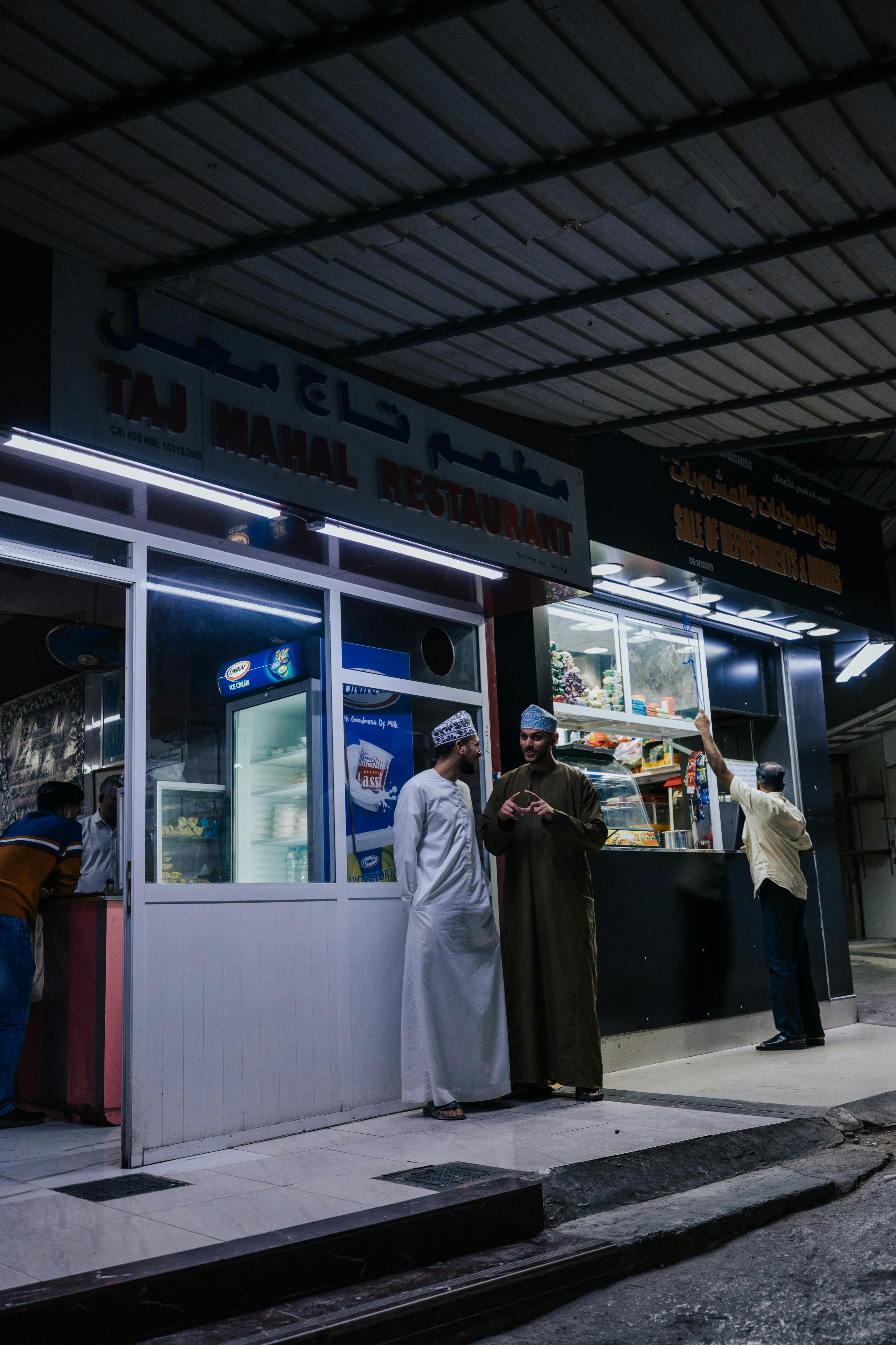 A candid evening moment outside Taj Mahal Restaurant in Muttrah, Muscat.