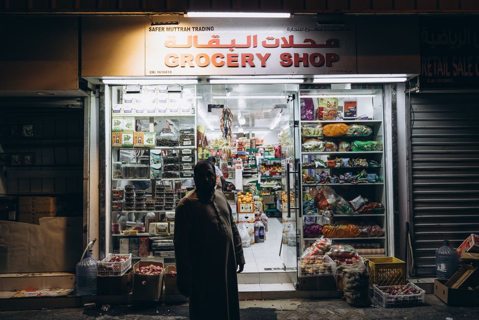 Bustling Souq Al-Mubarakiya in Kuwait, with stalls selling spices, textiles, and local goods.
