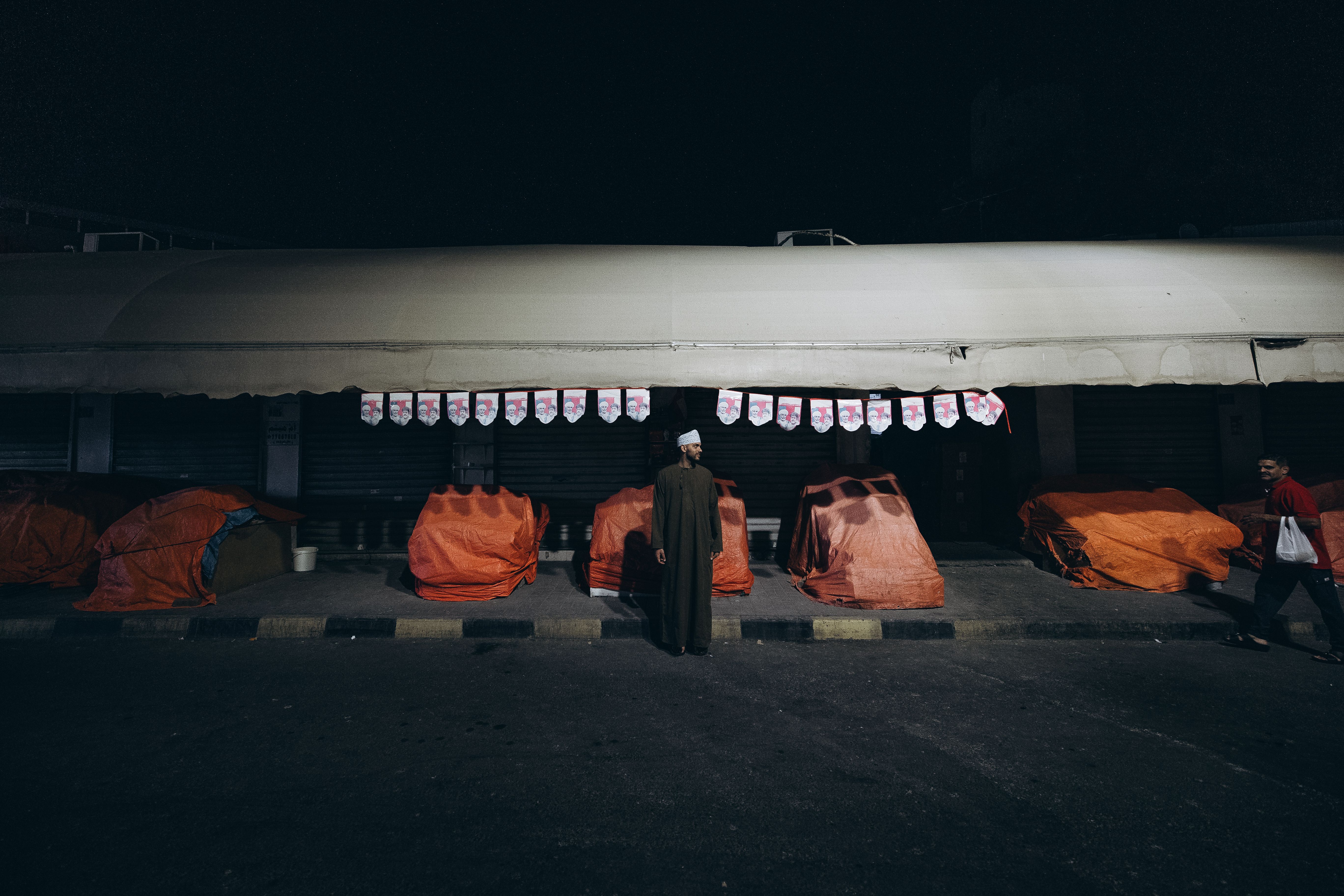 A candid capture of night life at Muttrah Souq, Muscat, Oman with locals in traditional attire.