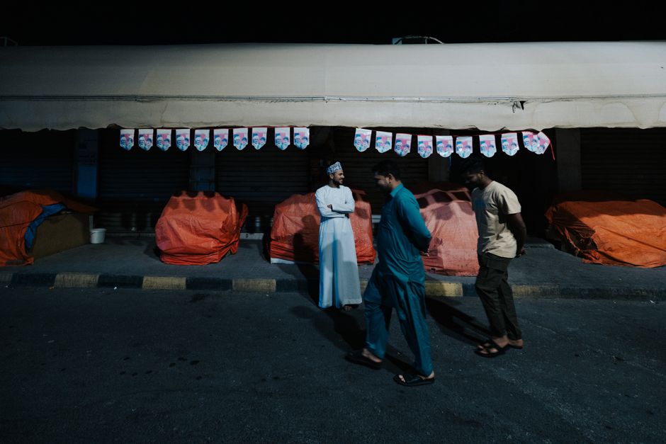 A lively evening scene in Manama Souq with vendors and shoppers