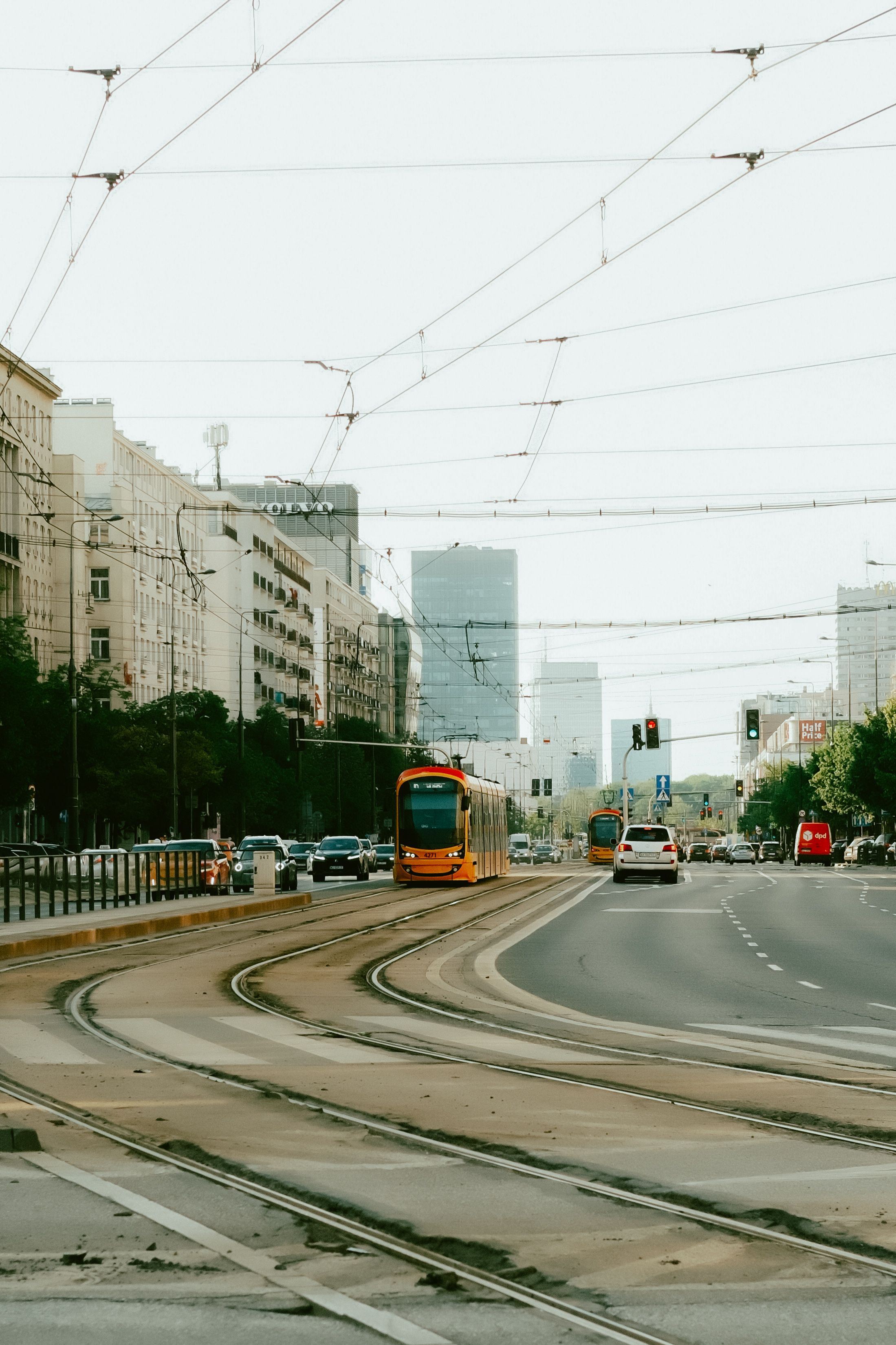 Vibrant city street in Warsaw with trams and traffic showcasing urban life.