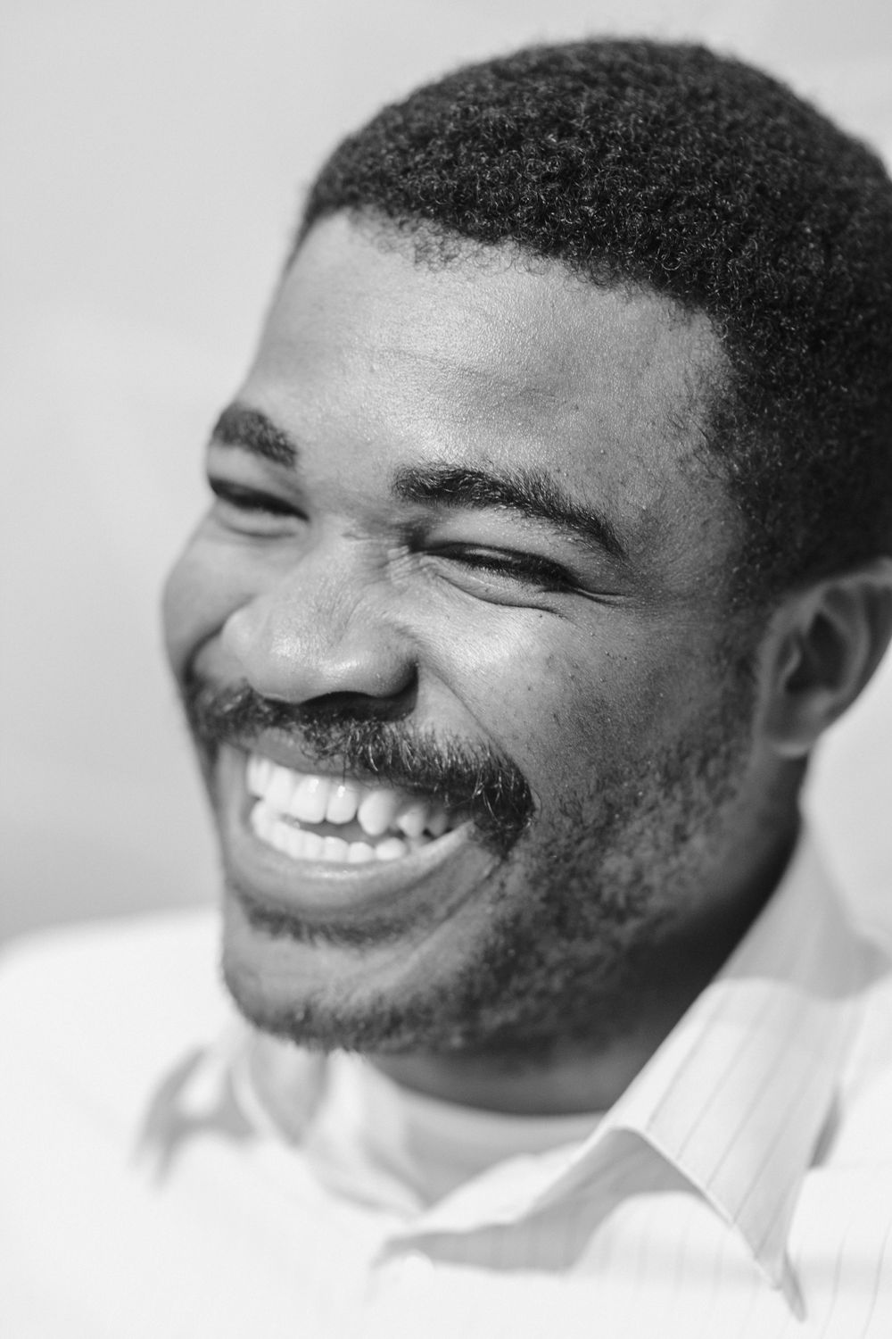 Joyful Black and White Portrait of a Smiling Man · Free Stock Photo