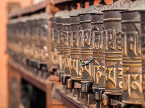Free Close-up of prayer wheels with Tibetan script at Swayambhunath Stupa, showcasing Buddhist culture. Stock Photo