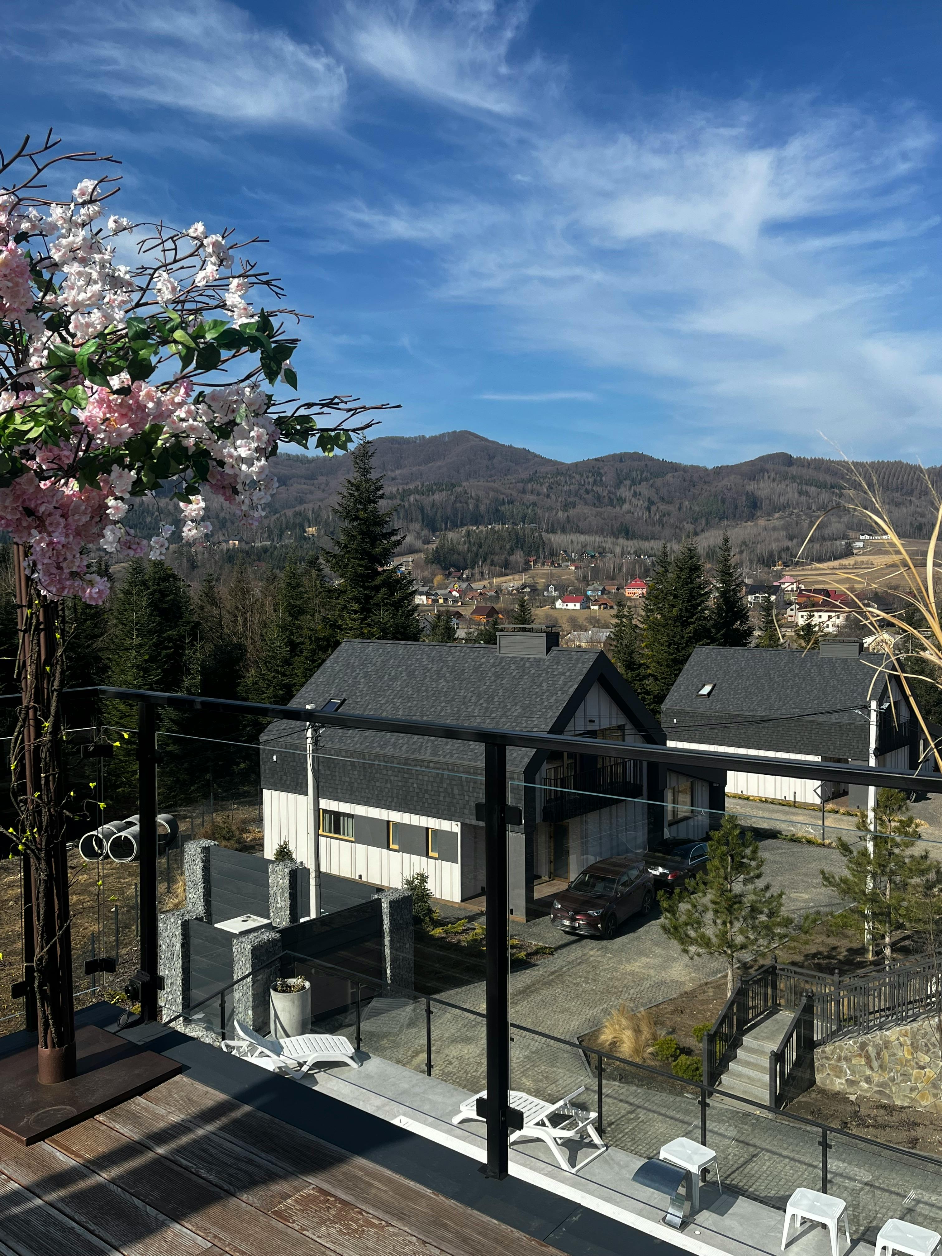 Peaceful suburban view with mountain backdrop in springtime, cherry blossoms bloom.