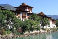 Scenic view of Punakha Dzong along a river with lush greenery in Bhutan.