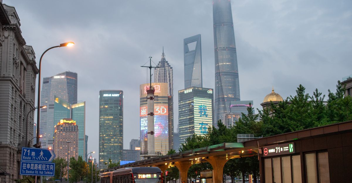 A bustling evening scene of Shanghai's skyline featuring the iconic skyscrapers and urban transit in Pudong.