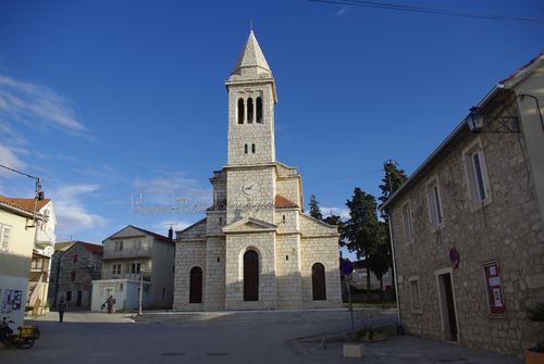 Free Beautiful stone church under a blue sky in Pakoštane, Croatia. Stock Photo