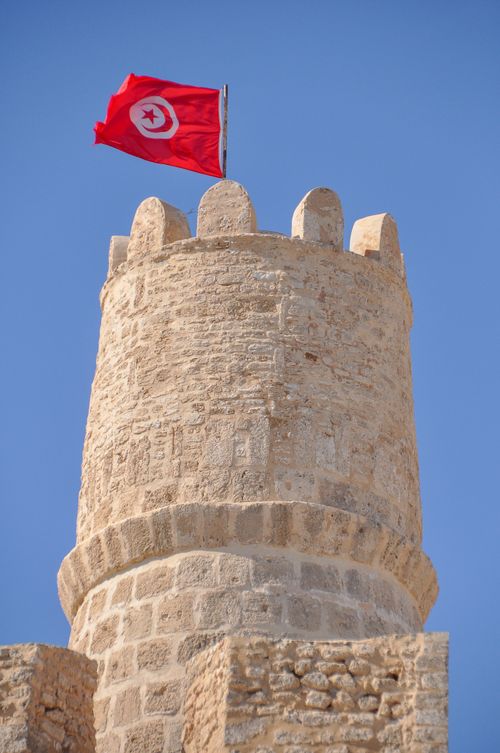 Free Ancient Ribat tower in Tunisia under a bright, clear sky. Perfect for travel and history themes. Stock Photo