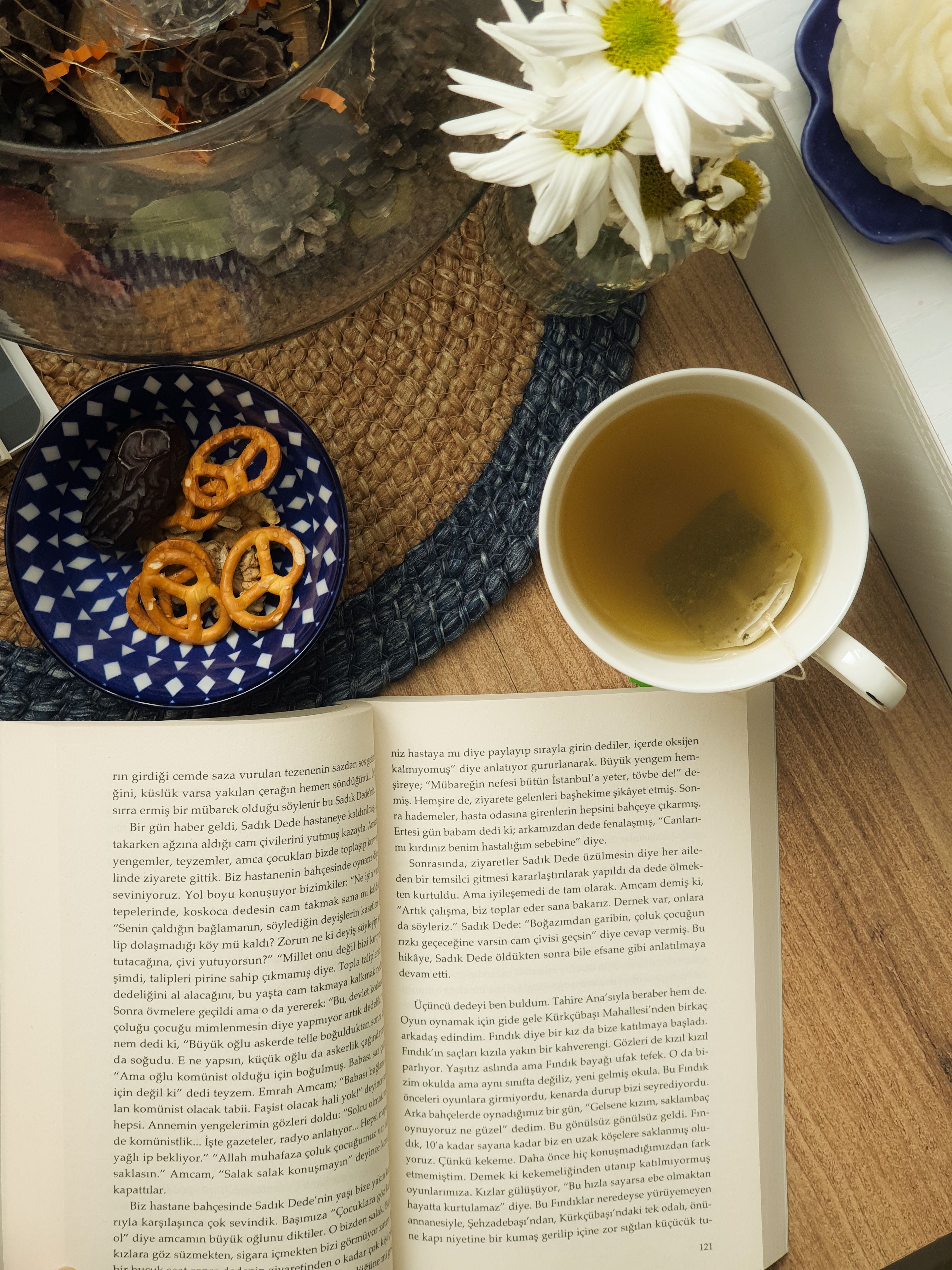 Cozy Reading Scene with Tea and Snacks · Free Stock Photo