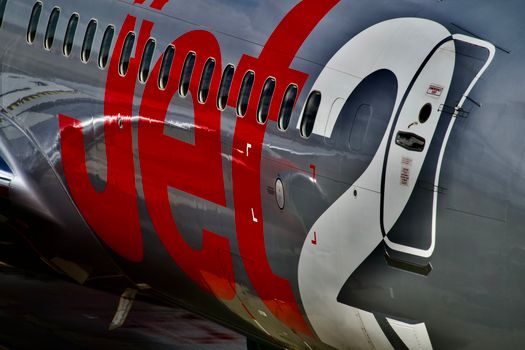 Detailed view of a commercial jet's exterior fuselage showing branding and windows.