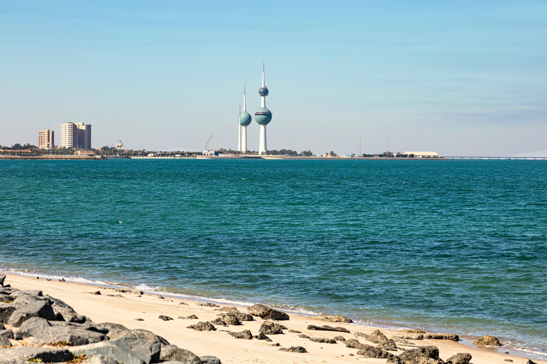 Scenic view of Kuwait Towers along the coastline, capturing the turquoise sea and sandy shore.. Photo by Tayssir Kadamany on Pexels