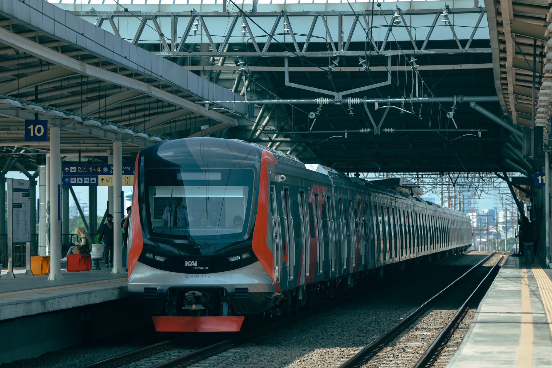 Dynamic view of a commuter train at Jakarta station, showcasing modern infrastructure.