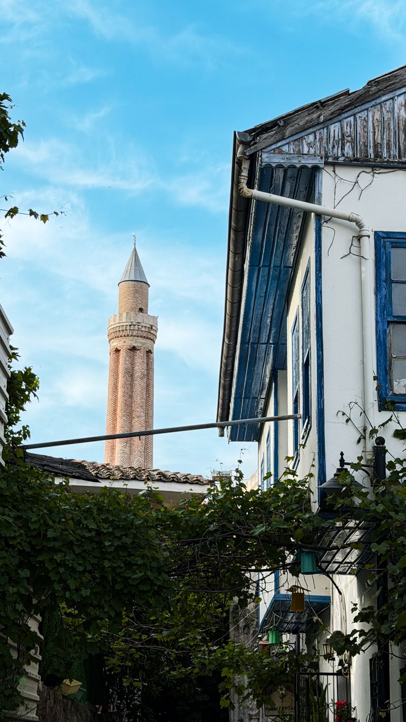Yivli Minaret rising above old-town houses in Antalya, Türkiye