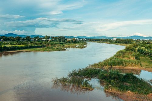 Free Serene river scene with lush greenery in Kon Tum, Vietnam, under clear skies. Stock Photo