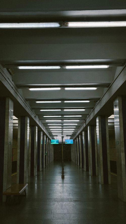 Free Empty subway platform with symmetrical architecture and bright overhead lighting. Stock Photo
