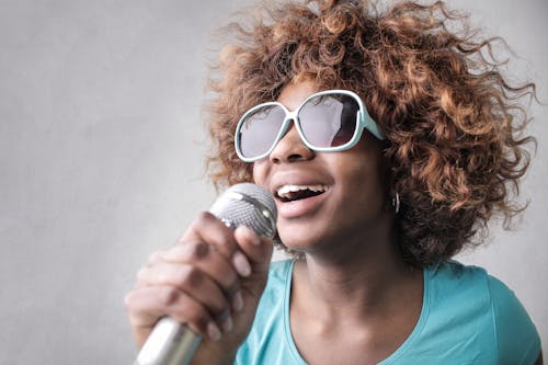 Free Woman Holding Microphone Stock Photo