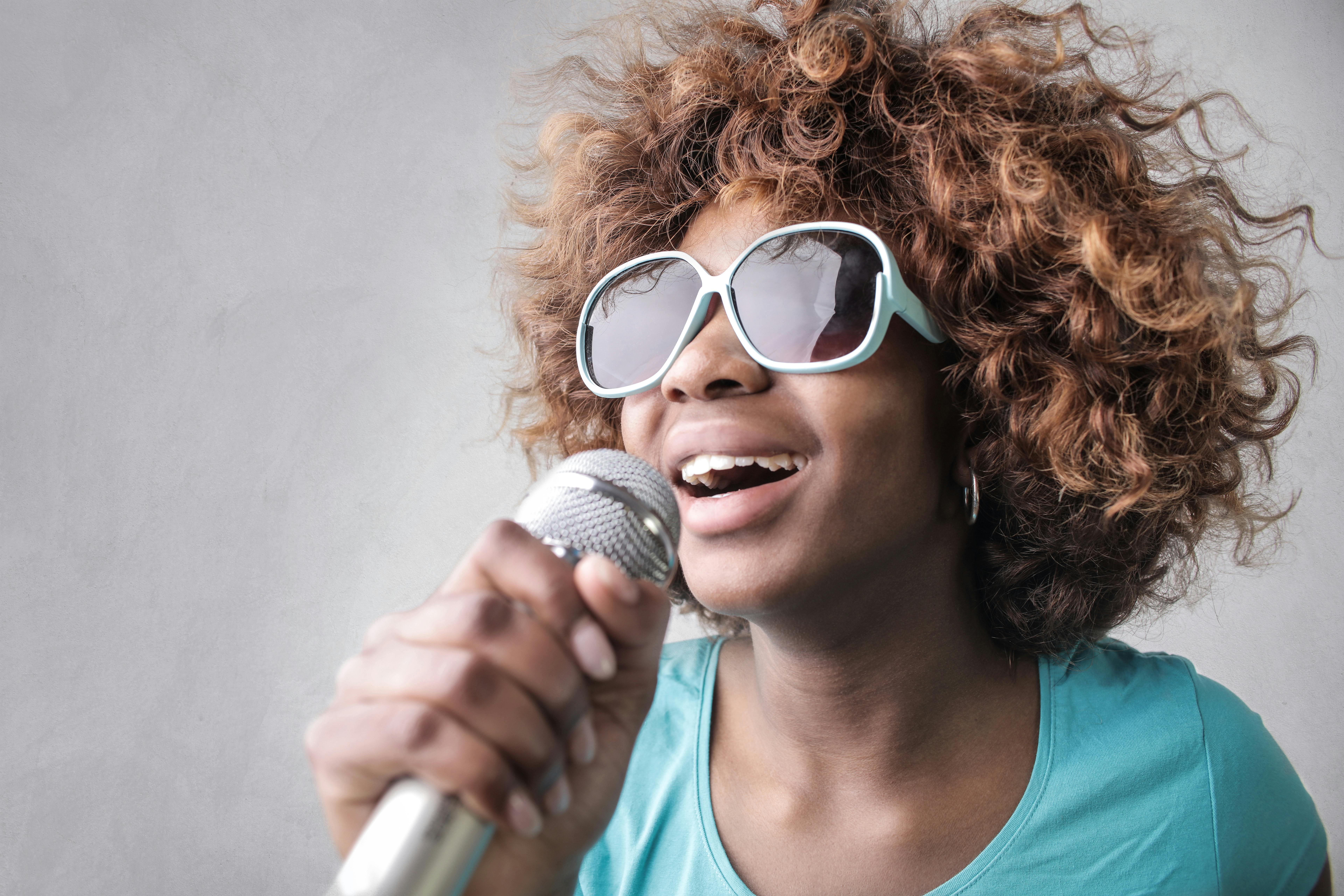 Woman Holding Microphone · Free Stock Photo