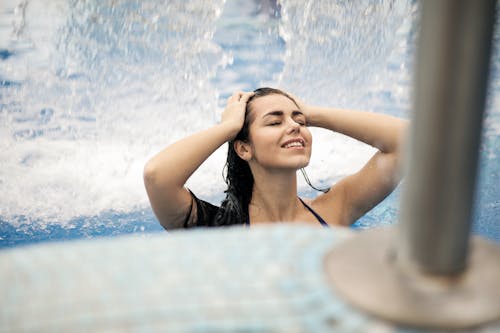 Free Woman in Black Tank Top on Swimming Pool Stock Photo