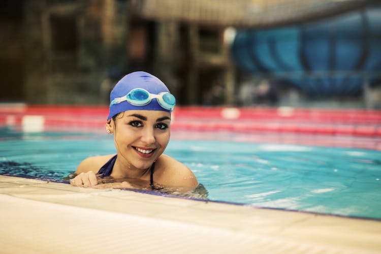 Woman In Blue Swimming Goggles In Swimming Pool