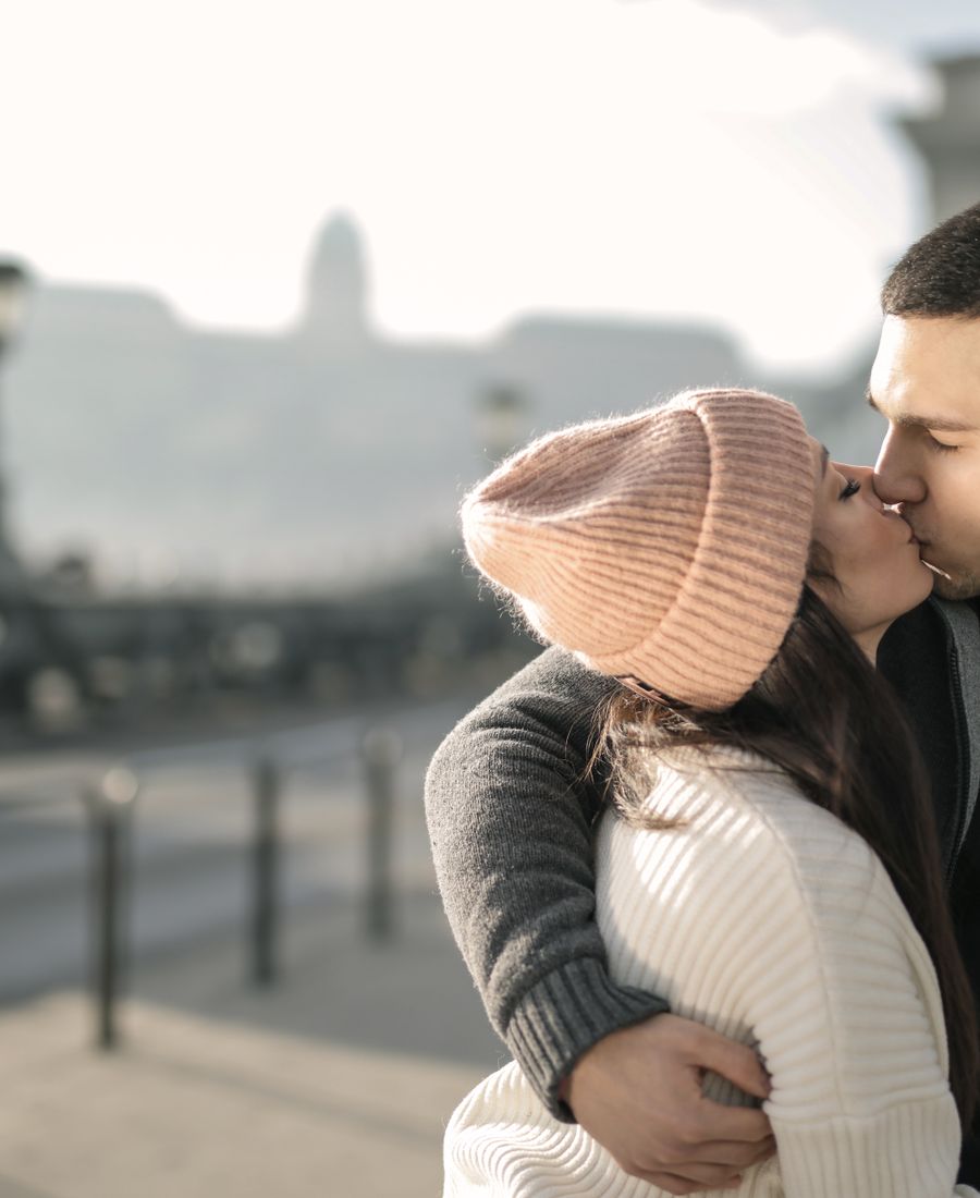 A couple reuniting and hugging outdoors