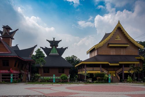 Free Beautiful wooden buildings with traditional architecture stand against a vibrant blue sky. Stock Photo