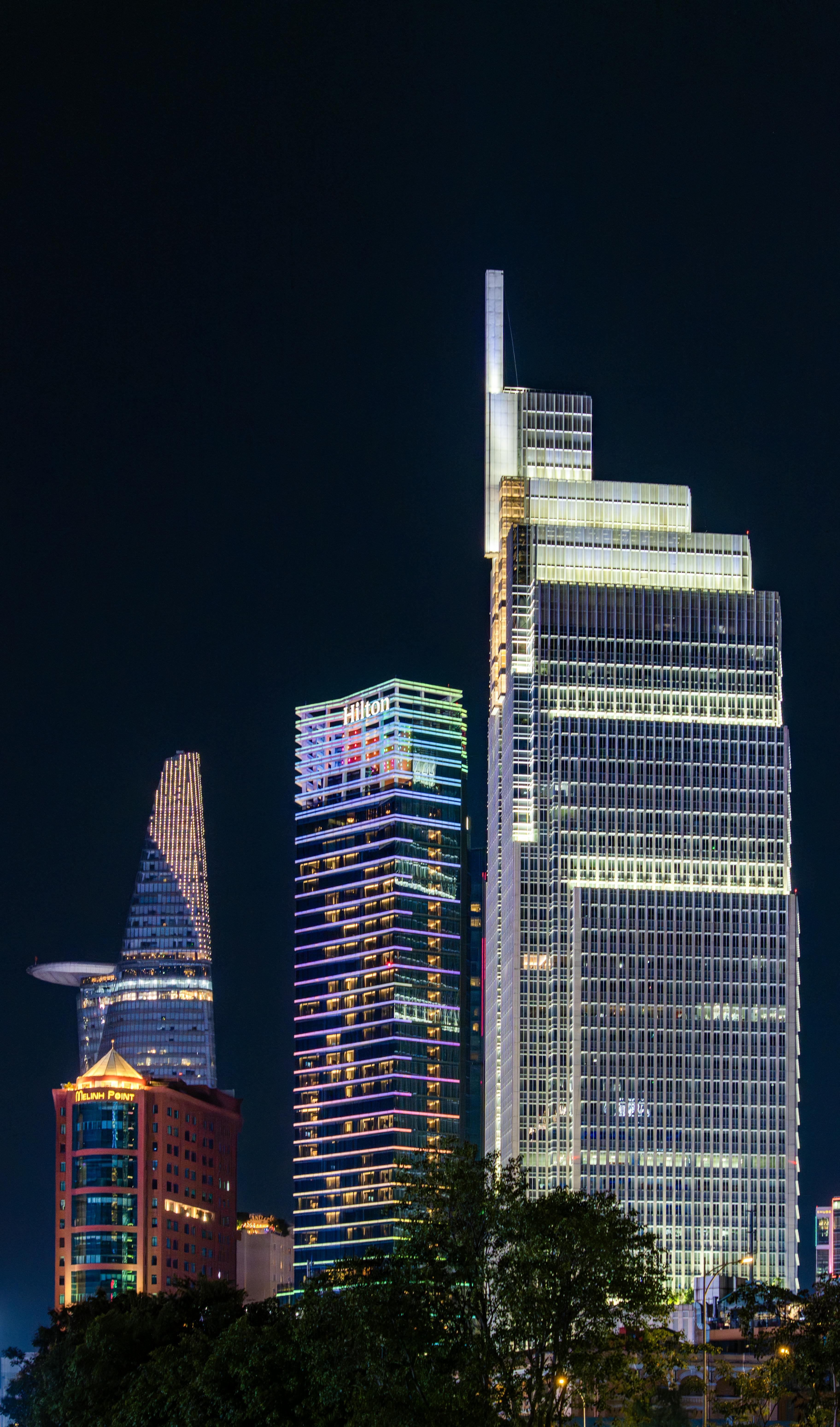 Dramatic night skyline featuring Bitexco Financial Tower in Ho Chi Minh City, Vietnam.