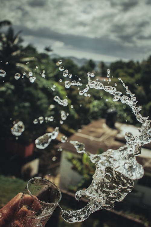 Free Person Throwing Glass of Water Stock Photo