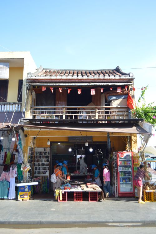 Free Charming storefront and bustling street market scene in Hoi An, Vietnam bustling with visitors. Stock Photo