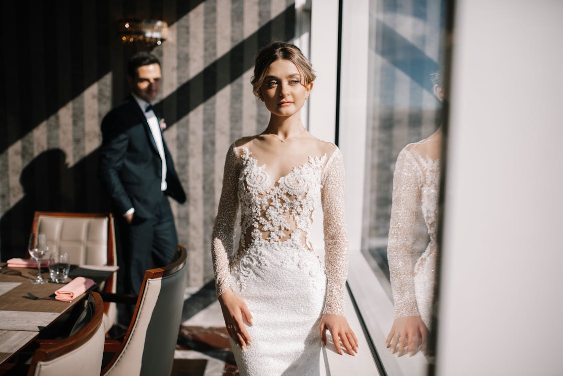 A woman wears a wedding dress with a beaded bodice