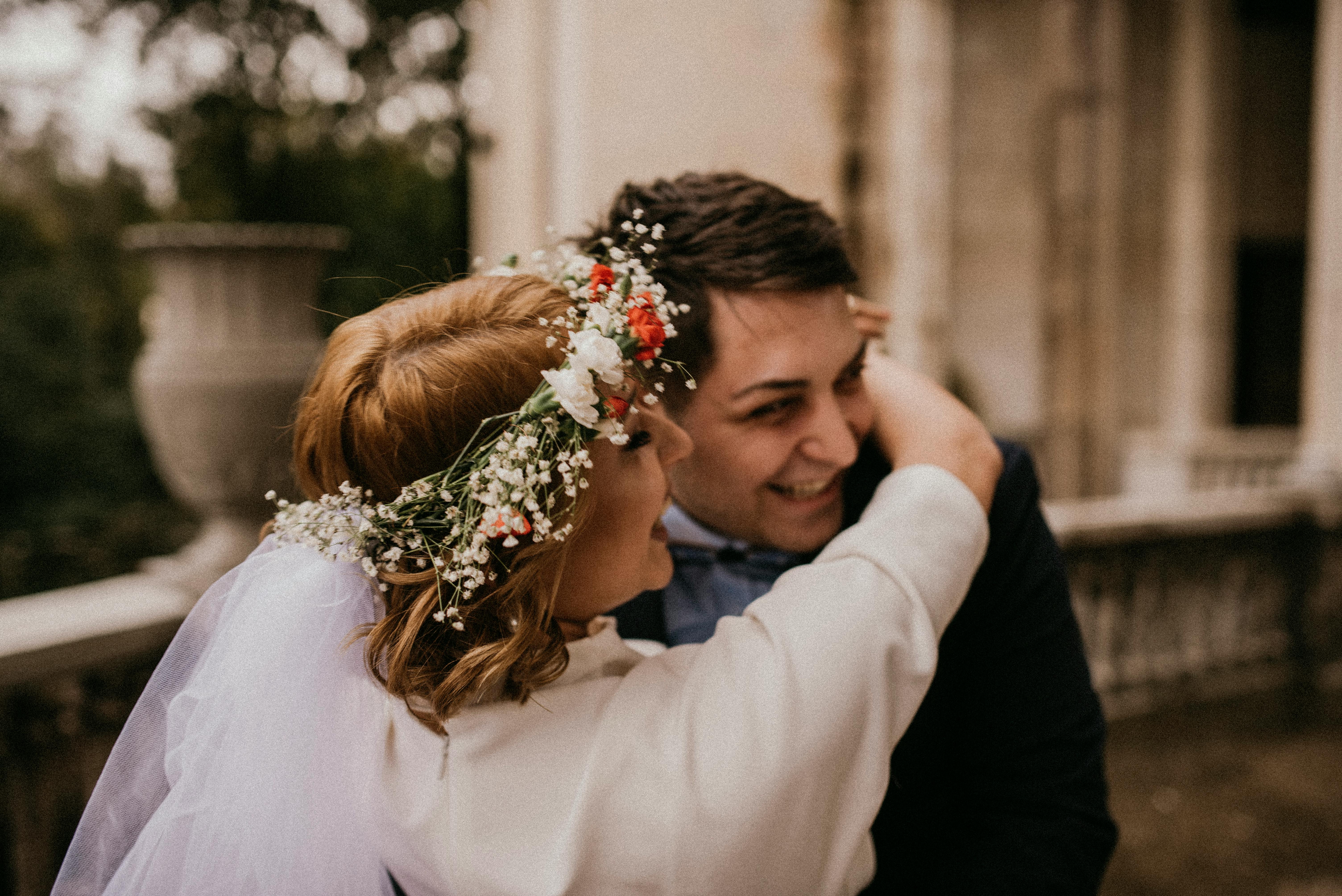 bride in white dress hugging her groom